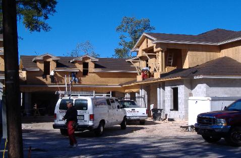 Mid-rise residential homes under construction on a clear day
